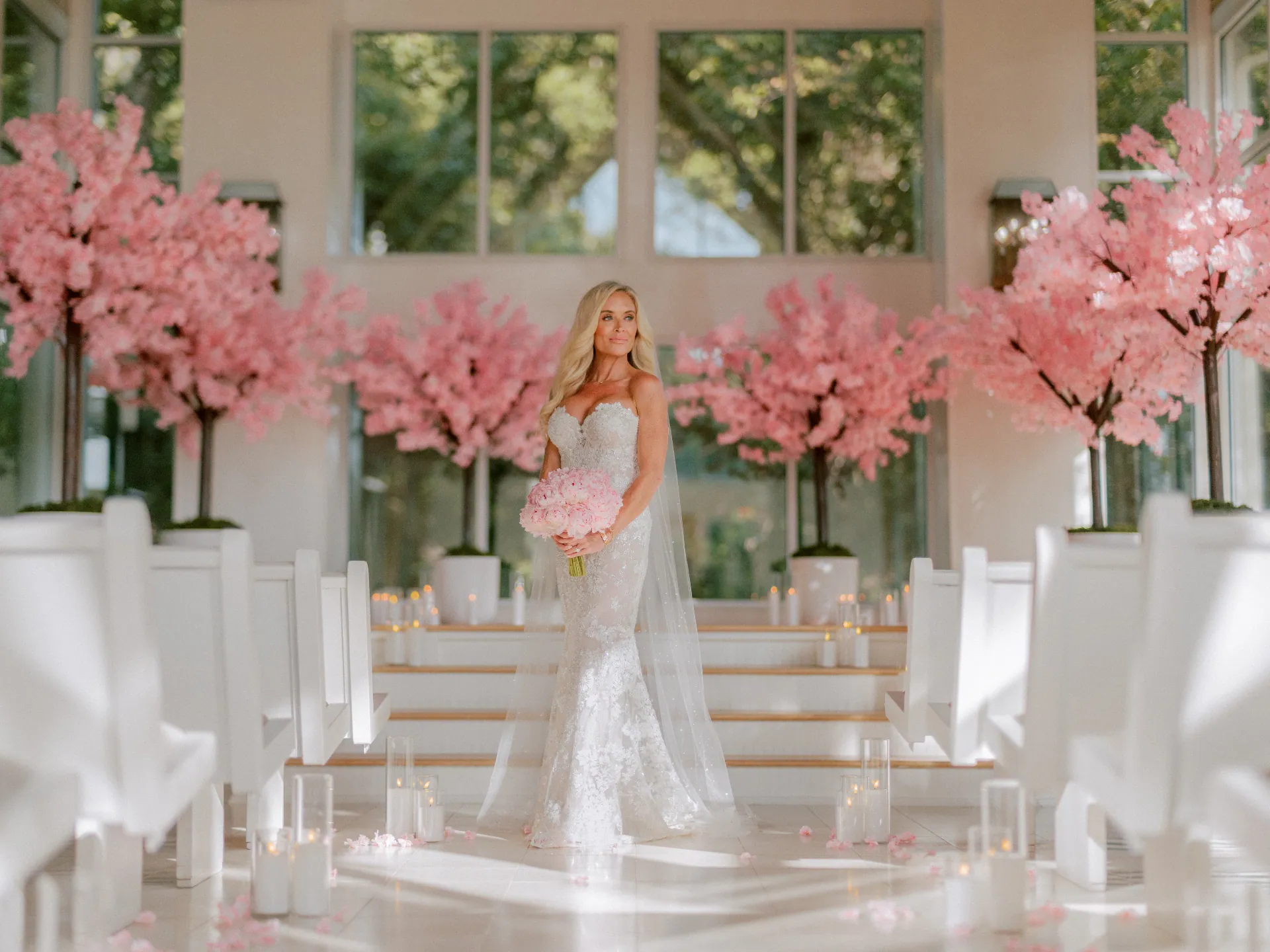 Bride in a white chapel framed by cherry blossoms