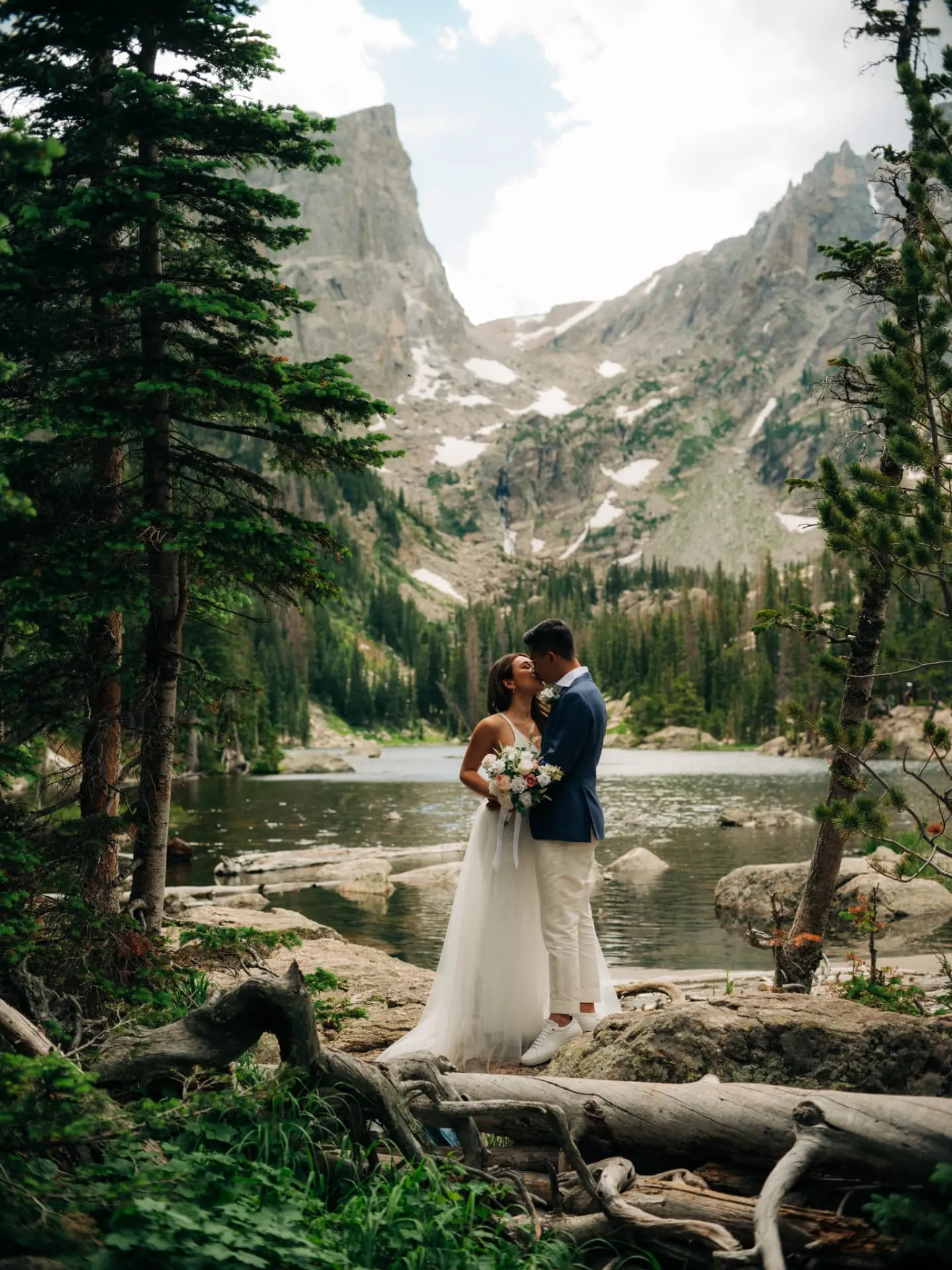 Couple kissing by an alpine lake in the Colorado mountains