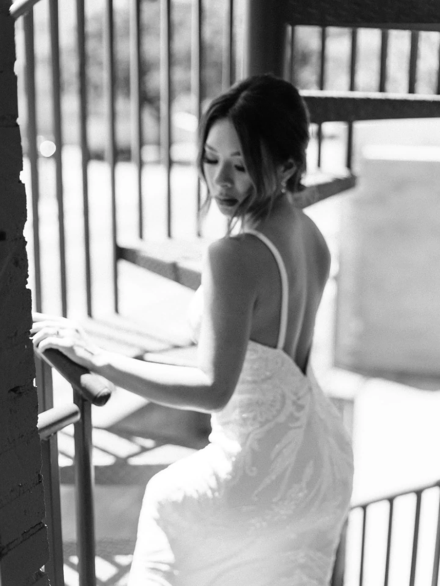 Black and white portrait of a bride on a fire escape