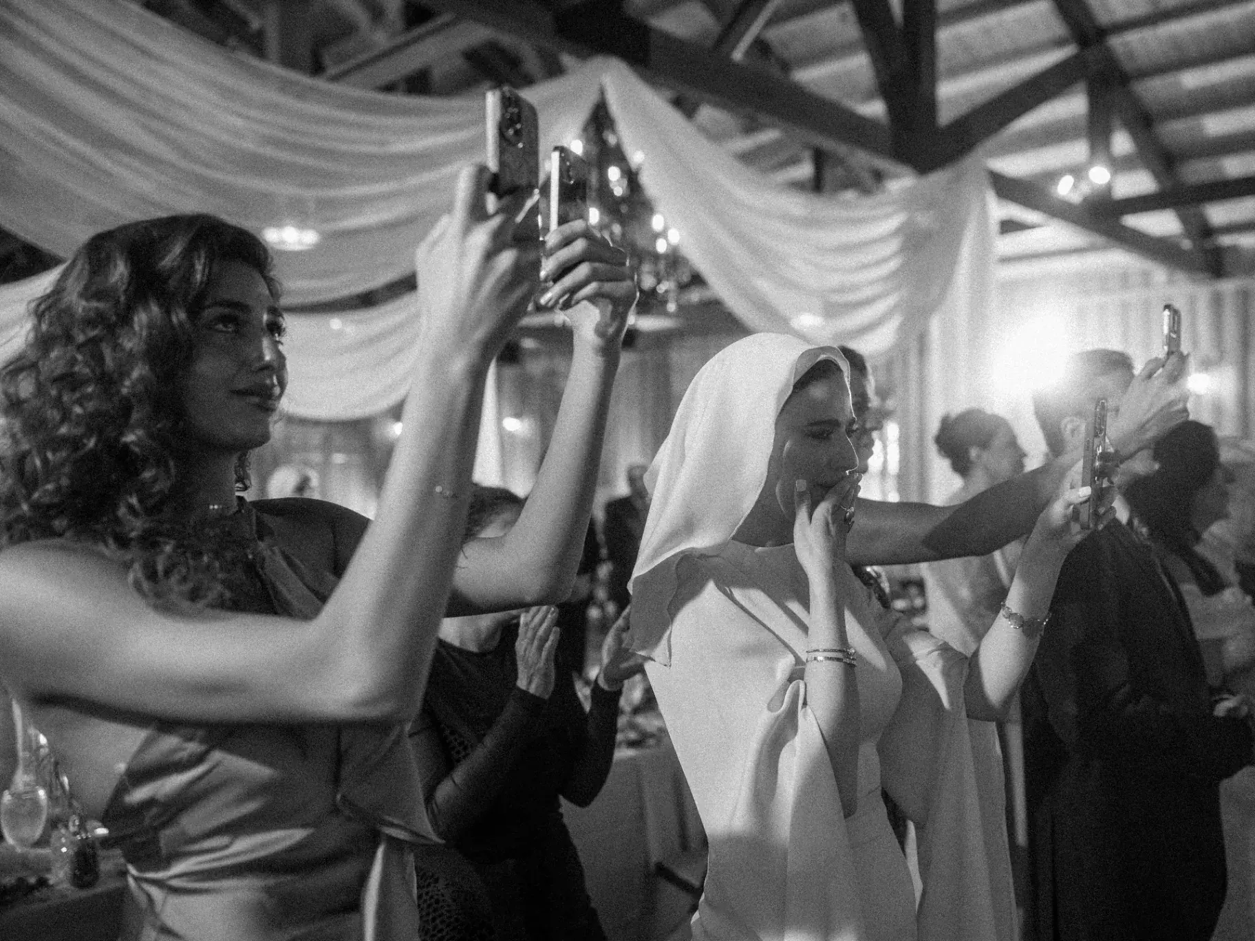 Guests, phones raised